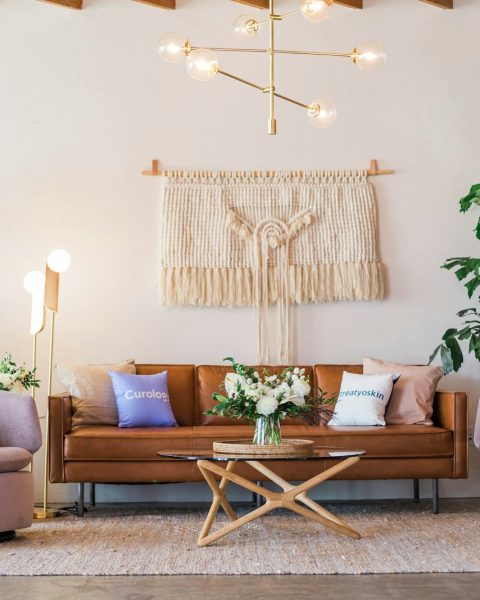 brown leather sofa and two pink sofa chair